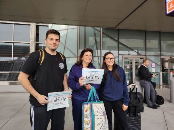 Happy Lets Fly Travel customer receiving a free airport drop